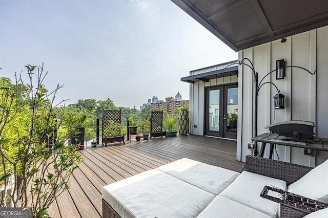 deck with an outdoor living space and french doors