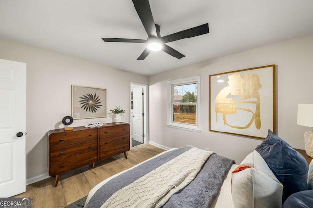 bedroom featuring a ceiling fan, wood finished floors, and baseboards