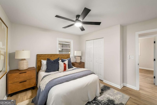 bedroom featuring a closet, ceiling fan, baseboards, and wood finished floors