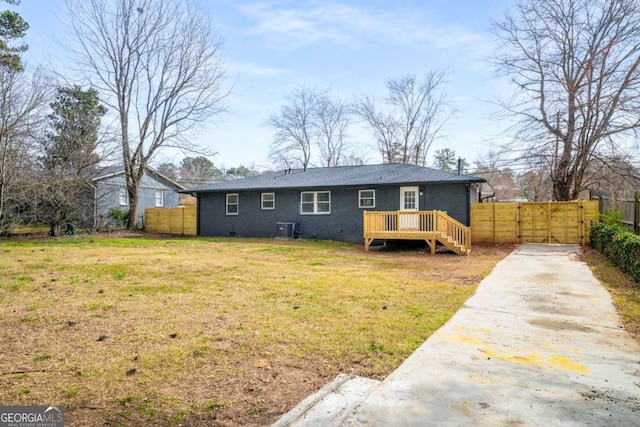 view of front of property featuring a front lawn, a gate, fence, a wooden deck, and crawl space