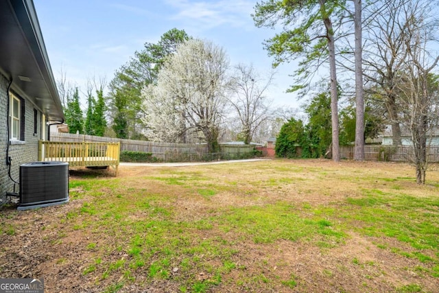 view of yard with fence and central AC