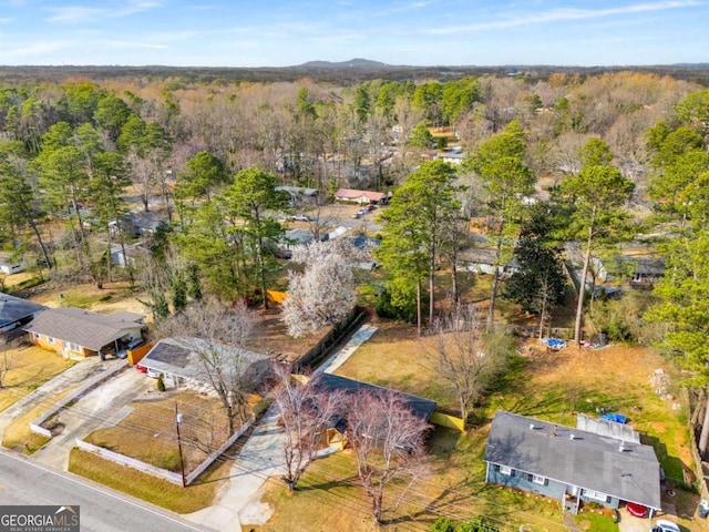 drone / aerial view featuring a forest view