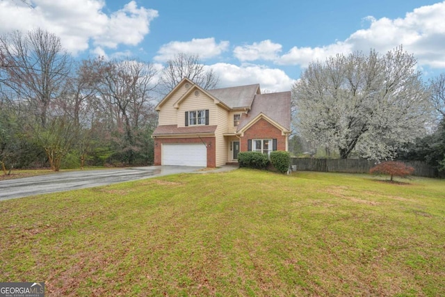 traditional-style home featuring brick siding, a front lawn, fence, a garage, and driveway