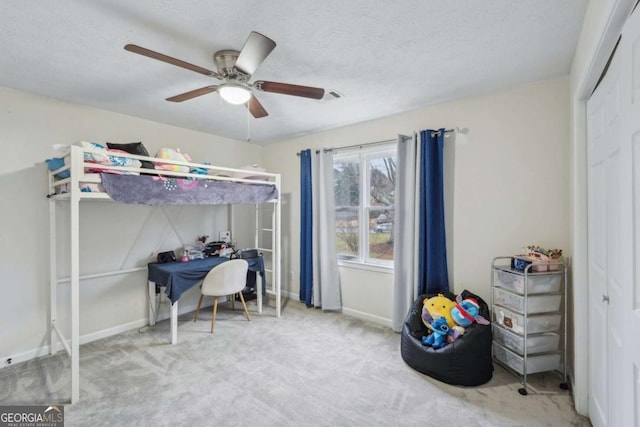 bedroom with visible vents, baseboards, carpet, a textured ceiling, and a ceiling fan