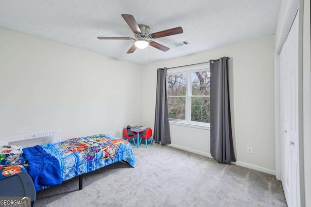 bedroom featuring a ceiling fan, carpet flooring, baseboards, and visible vents