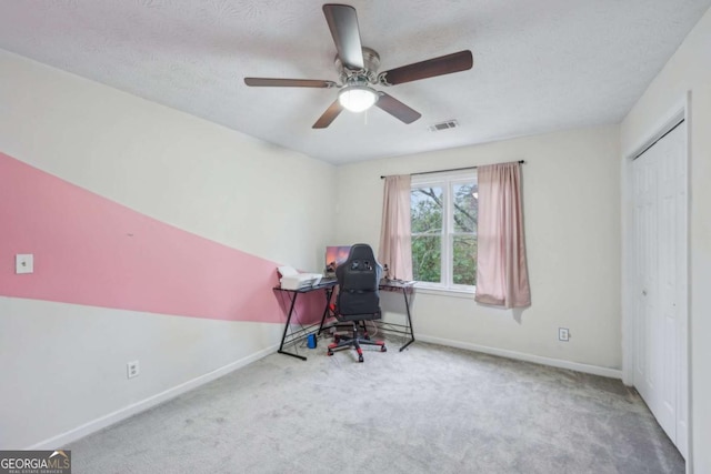 unfurnished office with visible vents, baseboards, carpet, and a textured ceiling