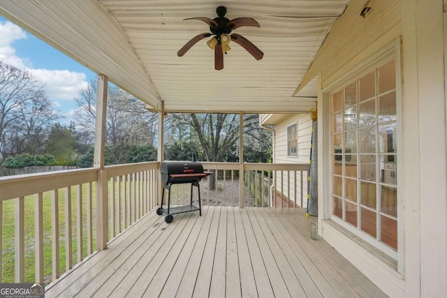 wooden deck featuring grilling area and a ceiling fan