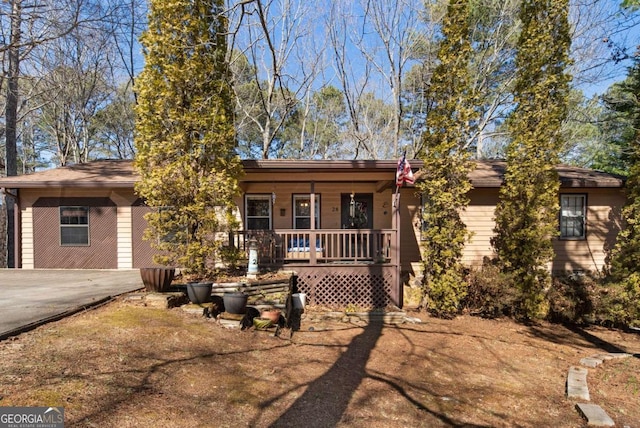 ranch-style house with a porch and driveway