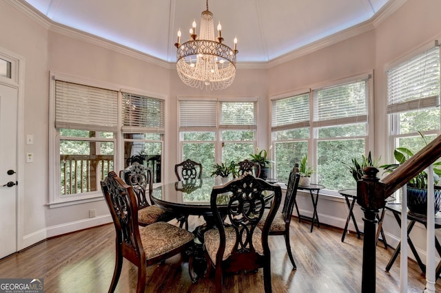 dining area with wood finished floors, baseboards, and ornamental molding