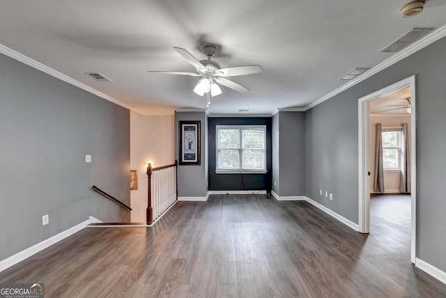interior space featuring dark wood finished floors, visible vents, and ornamental molding
