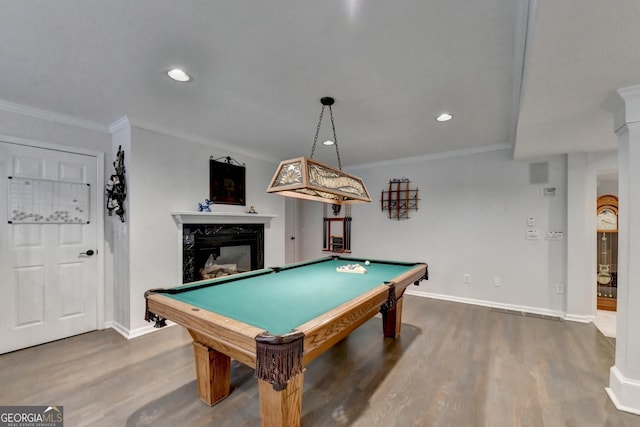 rec room with wood finished floors, a fireplace, baseboards, and ornamental molding