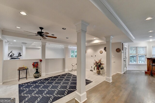 interior space featuring recessed lighting, decorative columns, wood finished floors, and ornamental molding