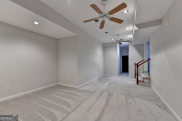 unfurnished living room with stairs, recessed lighting, baseboards, and light carpet