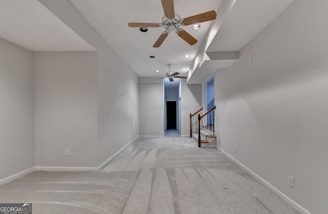 unfurnished living room with baseboards, light colored carpet, stairs, recessed lighting, and a ceiling fan