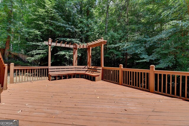wooden deck featuring a pergola