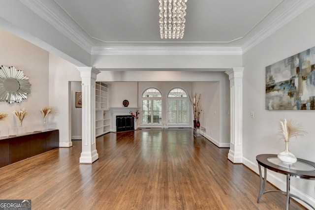 living room featuring decorative columns, baseboards, wood finished floors, and a fireplace