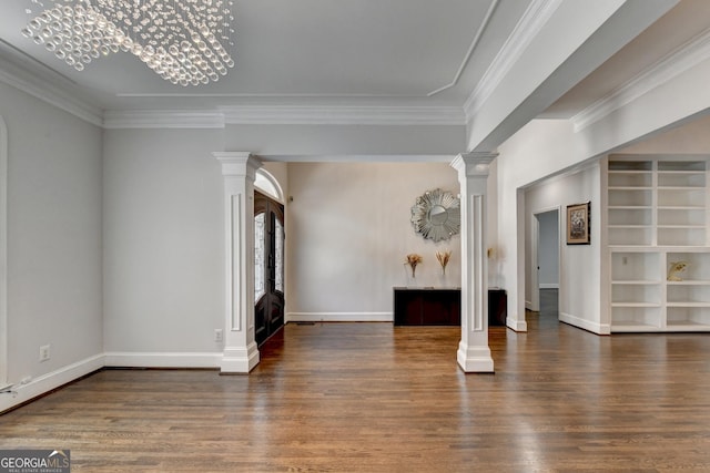 interior space featuring ornamental molding, wood finished floors, baseboards, and decorative columns