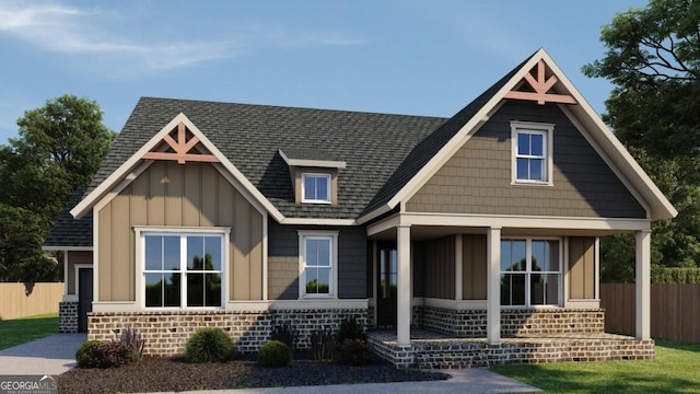 view of front facade featuring fence, board and batten siding, and roof with shingles