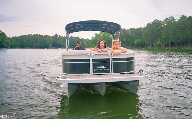 dock area with a wooded view and a water view