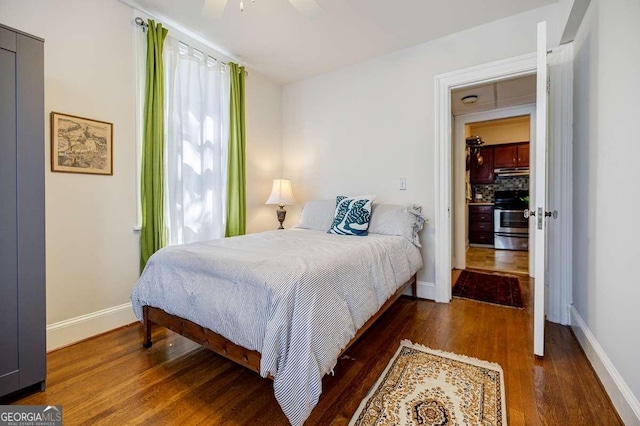 bedroom with baseboards, wood finished floors, and a ceiling fan