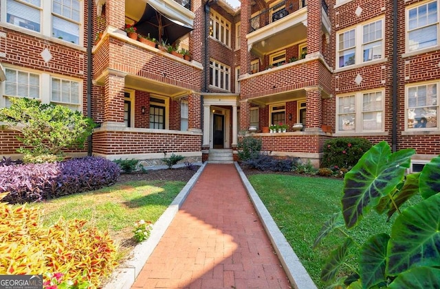 view of exterior entry with brick siding