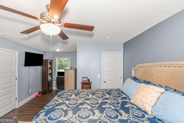 bedroom with visible vents, baseboards, wood finished floors, and a ceiling fan