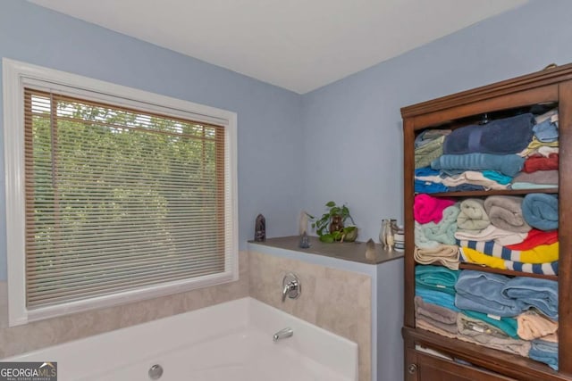 full bathroom featuring a wealth of natural light and a garden tub