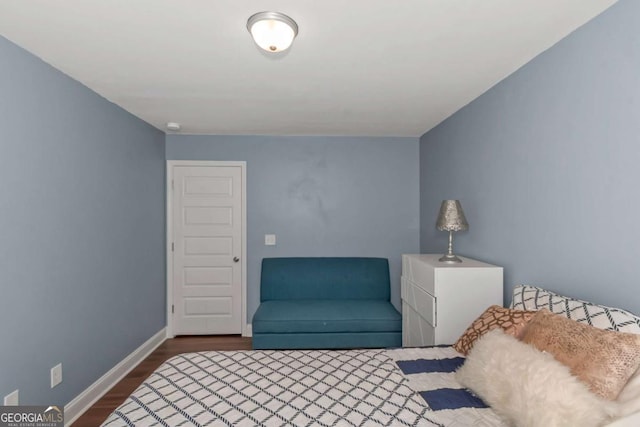 bedroom with baseboards and dark wood-style flooring