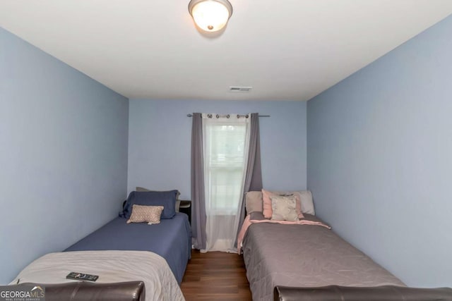 bedroom with wood finished floors and visible vents