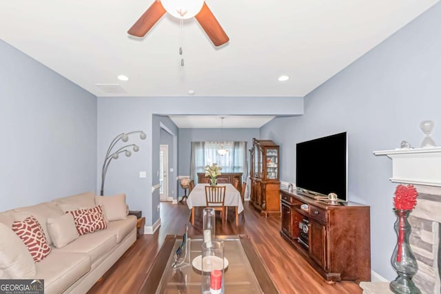 living room featuring recessed lighting, ceiling fan, baseboards, and wood finished floors