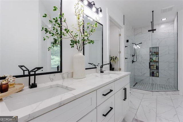 bathroom with a marble finish shower, marble finish floor, and a sink