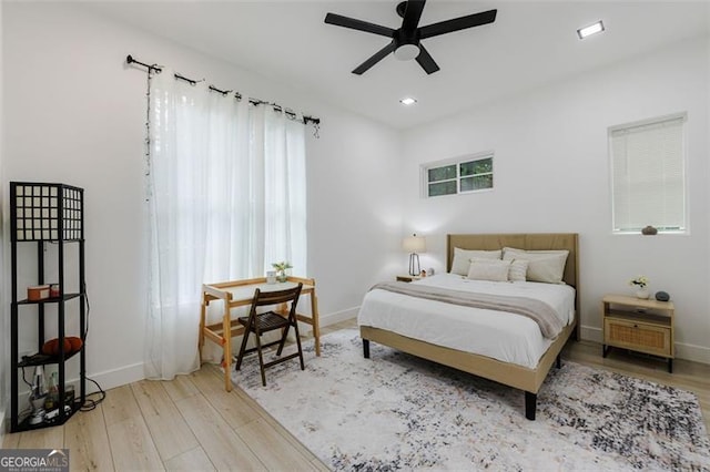 bedroom with recessed lighting, baseboards, and wood finished floors