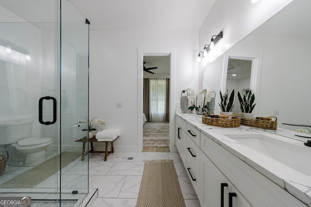 ensuite bathroom with a sink, toilet, marble finish floor, and a stall shower