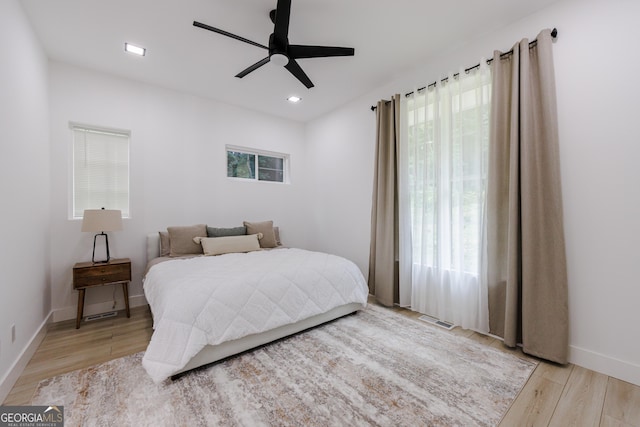 bedroom featuring visible vents, a ceiling fan, recessed lighting, light wood-style floors, and baseboards