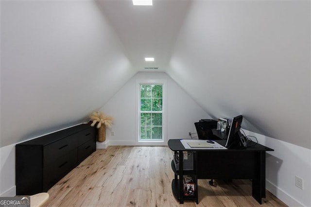 office with lofted ceiling, wood finished floors, visible vents, and baseboards