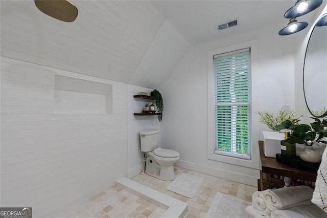 full bathroom with lofted ceiling, toilet, baseboards, and visible vents