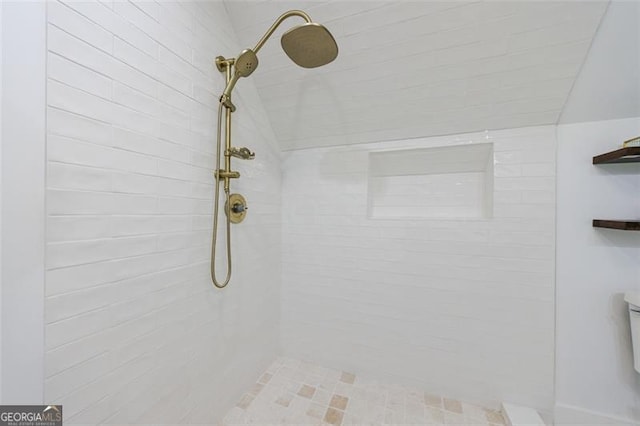 bathroom with a tile shower