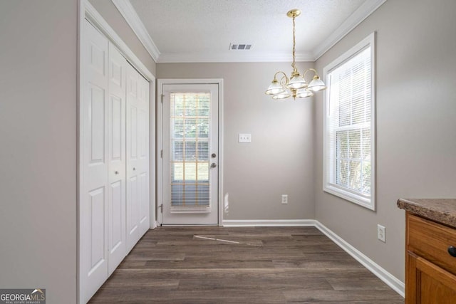 doorway to outside featuring baseboards, visible vents, dark wood finished floors, a textured ceiling, and crown molding