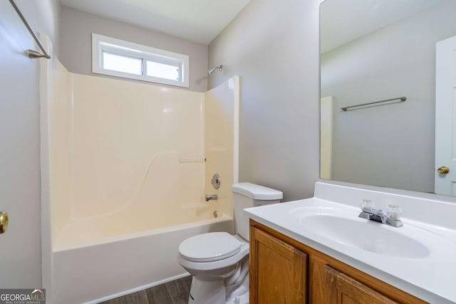 full bath with vanity, toilet, wood finished floors, and shower / bathtub combination