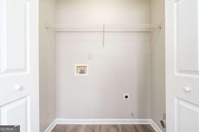 washroom featuring baseboards, washer hookup, laundry area, wood finished floors, and hookup for an electric dryer