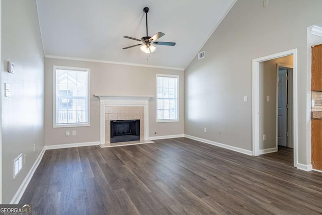 unfurnished living room with crown molding, visible vents, dark wood-style flooring, and a tile fireplace