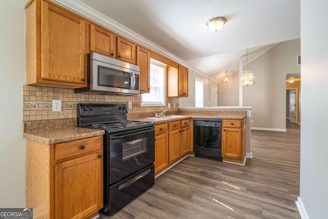 kitchen featuring a peninsula, lofted ceiling, dark wood-style flooring, decorative backsplash, and black appliances