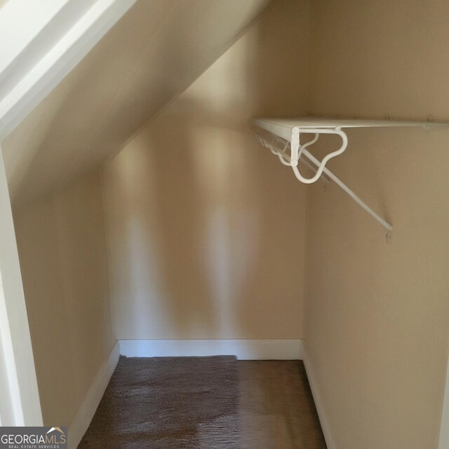 hallway with baseboards and wood finished floors