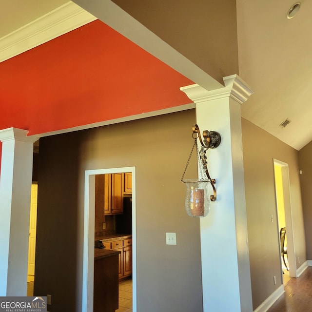 empty room featuring a chandelier, baseboards, high vaulted ceiling, and wood finished floors