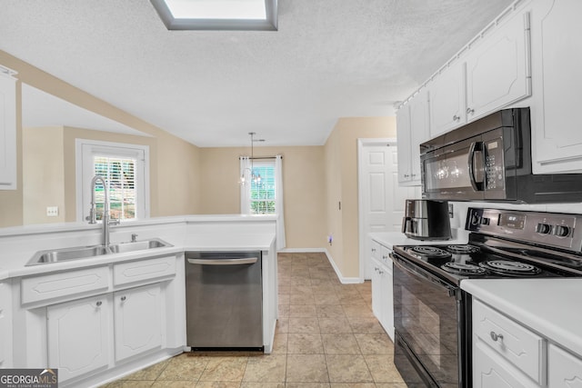 kitchen featuring white cabinetry, black appliances, light countertops, and a sink