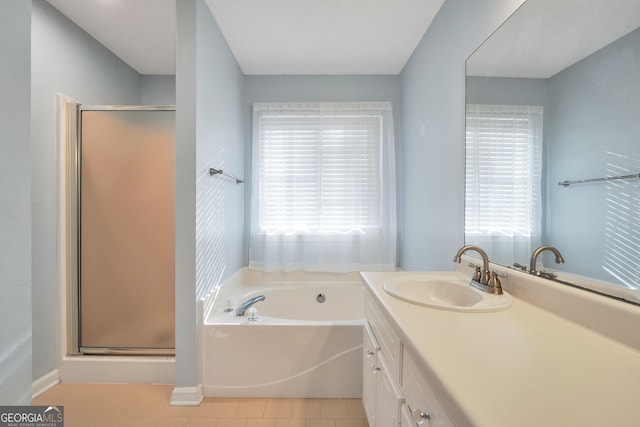 bathroom featuring tile patterned flooring, a shower stall, a bath, and a healthy amount of sunlight