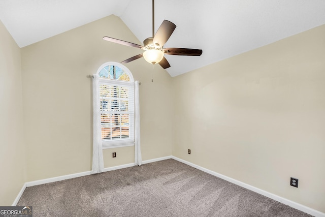 carpeted spare room featuring lofted ceiling, a ceiling fan, and baseboards