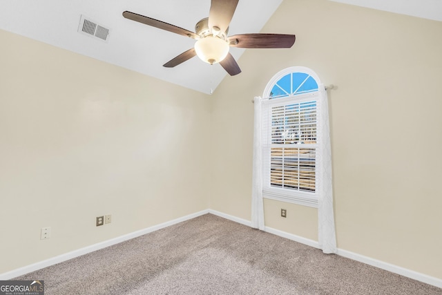 spare room featuring a ceiling fan, baseboards, visible vents, carpet floors, and vaulted ceiling