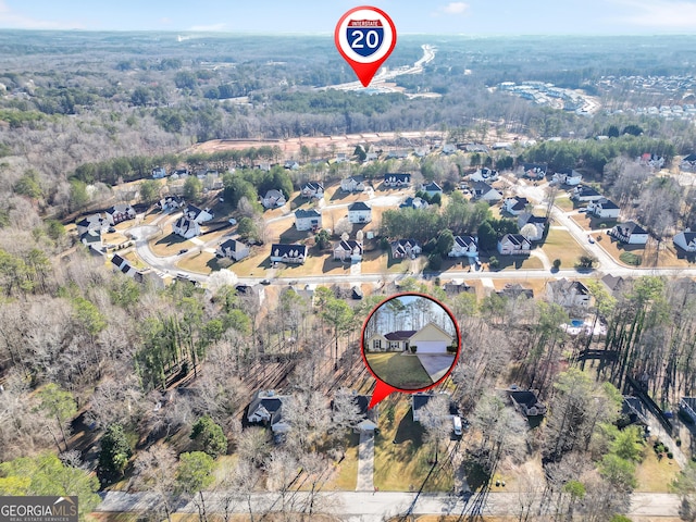 birds eye view of property with a view of trees