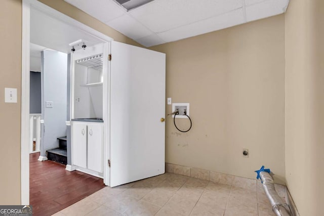 bathroom featuring a drop ceiling and tile patterned flooring